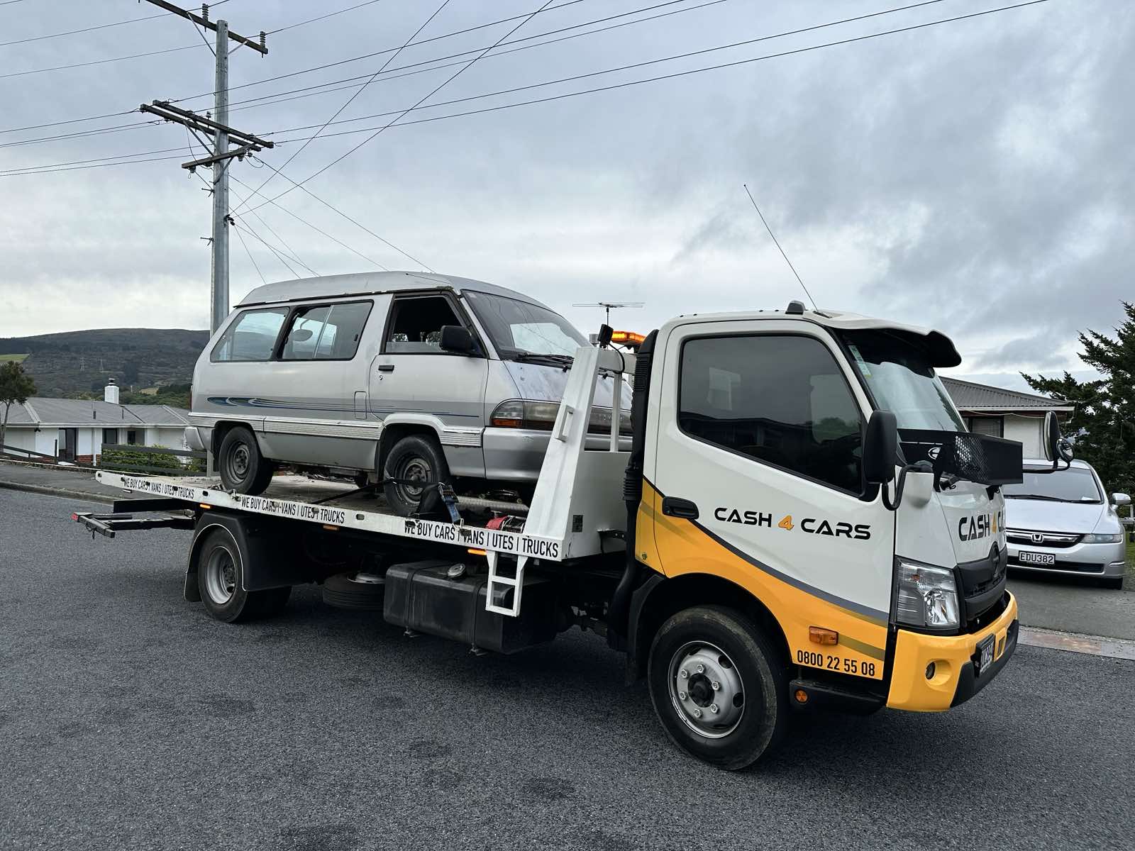 Cash 4 Cars removal truck carrying a used van